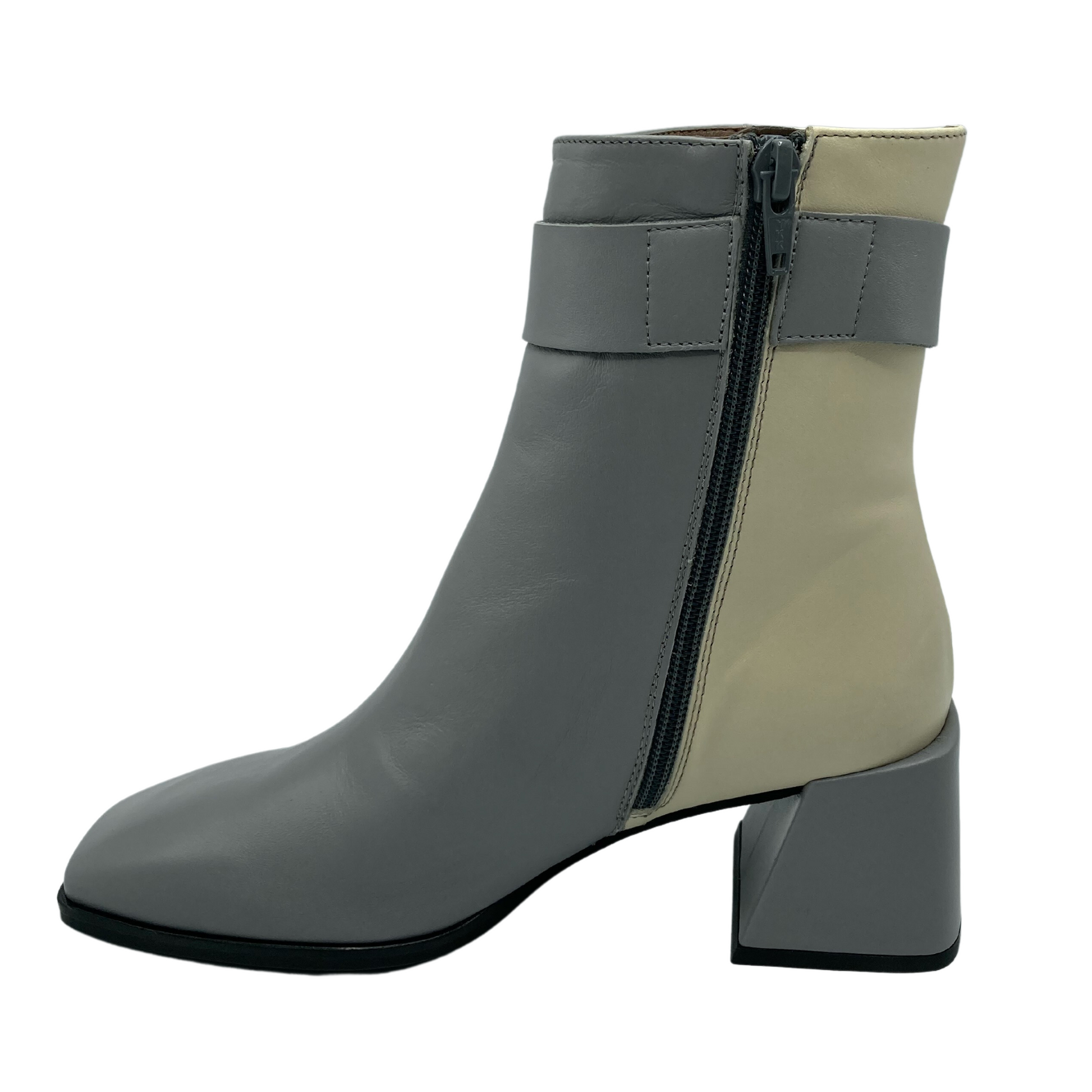 Inside profile view of grey and cream boot with dark grey zipper from bottom to top