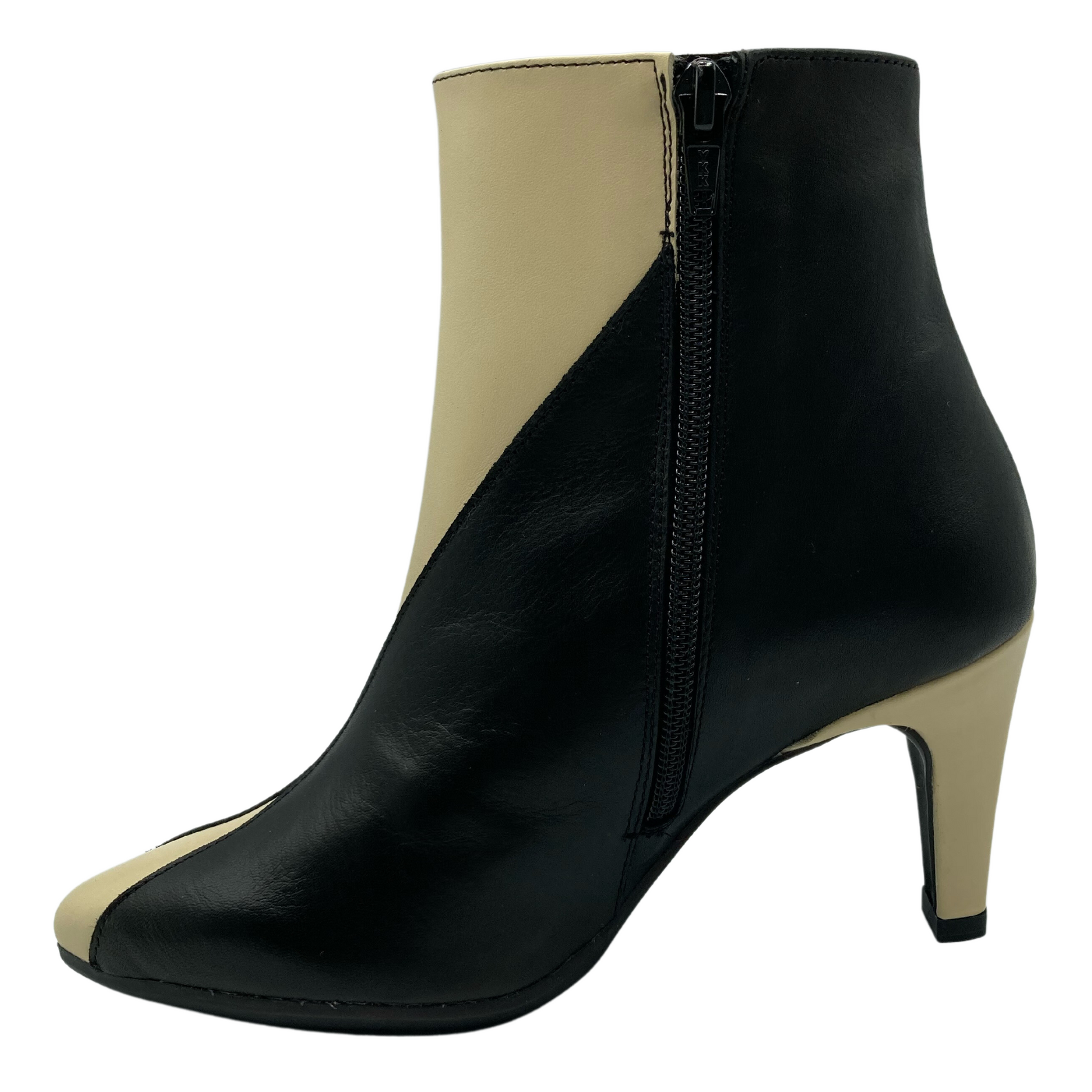 Left facing view of black and cream leather short bootie with side zipper closure and kitten heel