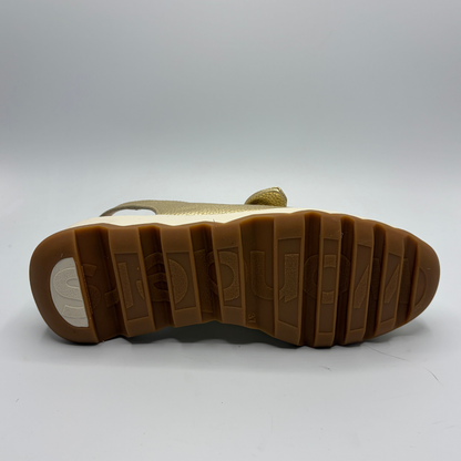 Close-up of a shoe sole with a white label on a light gray background