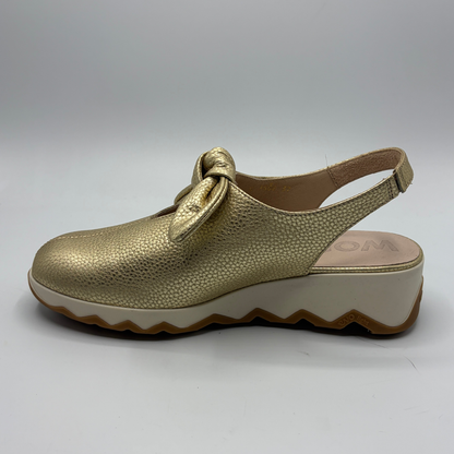 Gold clog shoe on a white background