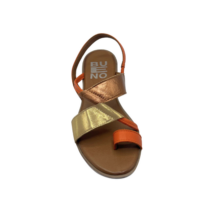 Top down view of a flat sandal shown in a combo of orange, gold and rose gold leather.