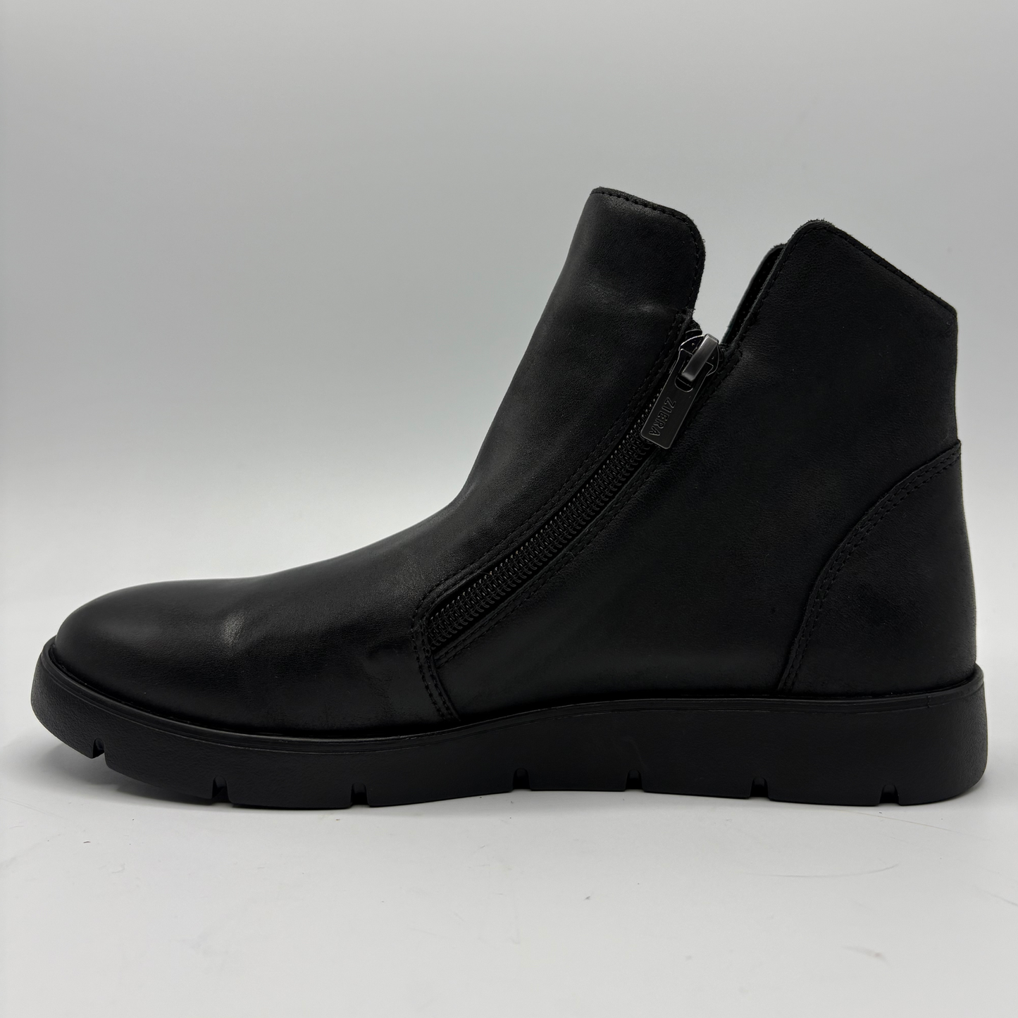 A single black leather ankle boot with a side zipper, shown in a side profile view against a light gray background.