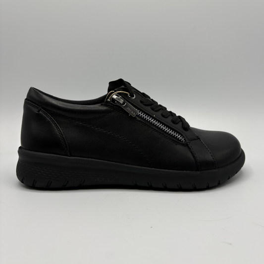 Black leather sneaker with a zipper on a gray background