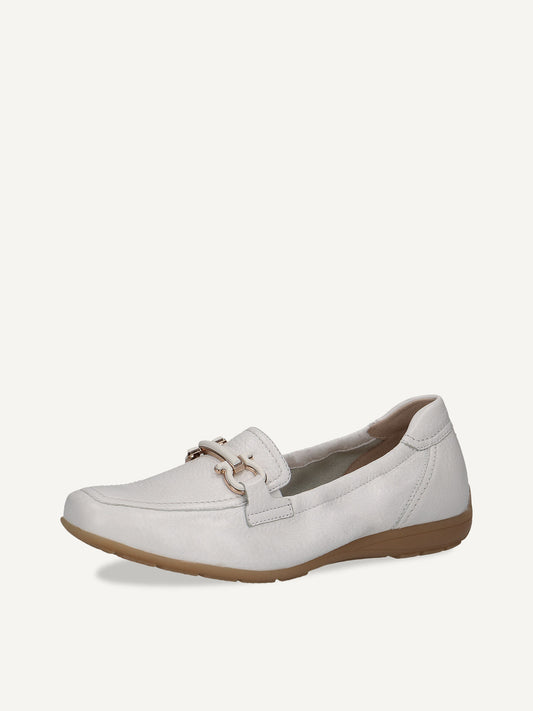 White  loafer shoe on a beige background