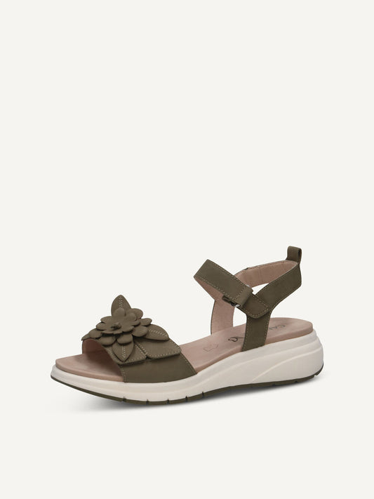 Green sandal with a flower detail on a white background