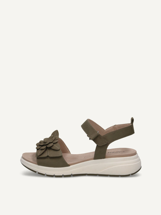 Brown sandal with a decorative bow on a white background