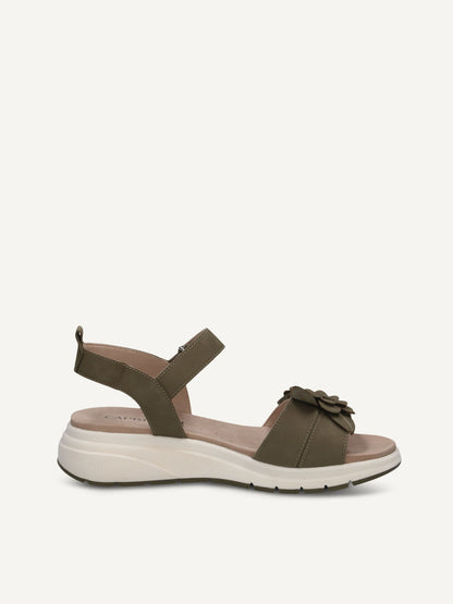 Green sandal with ruffle detail on a white background