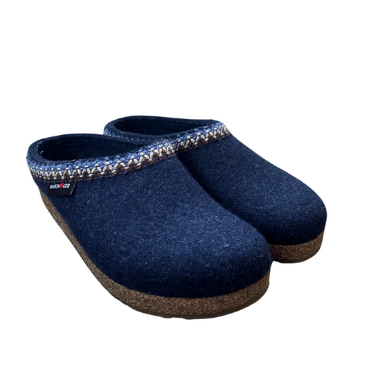 Angled view of a pair of wool slippers in a navy colour with stitched zigzag detail on upper. Wool lined and featuring anatomically correct cork footbeds