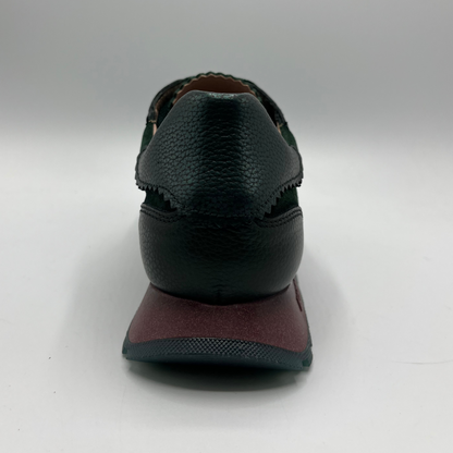 Green shoe with a brown sole on a white background