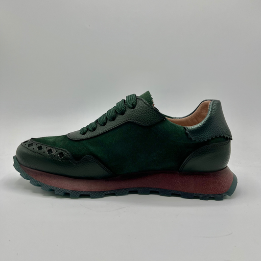 Green sneaker with brown sole on a white background