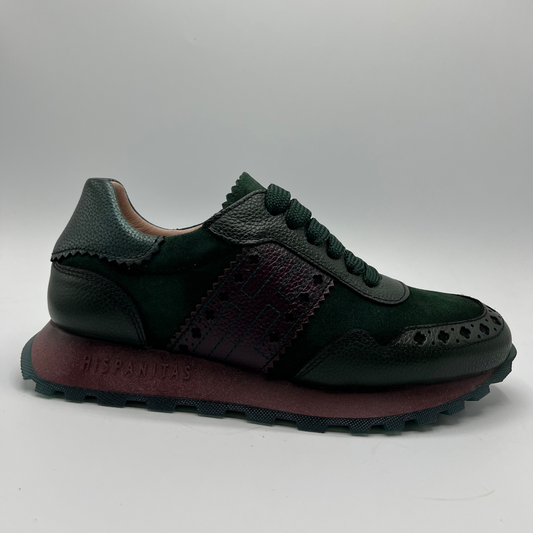 Dark green sneaker with brown sole on a gray background