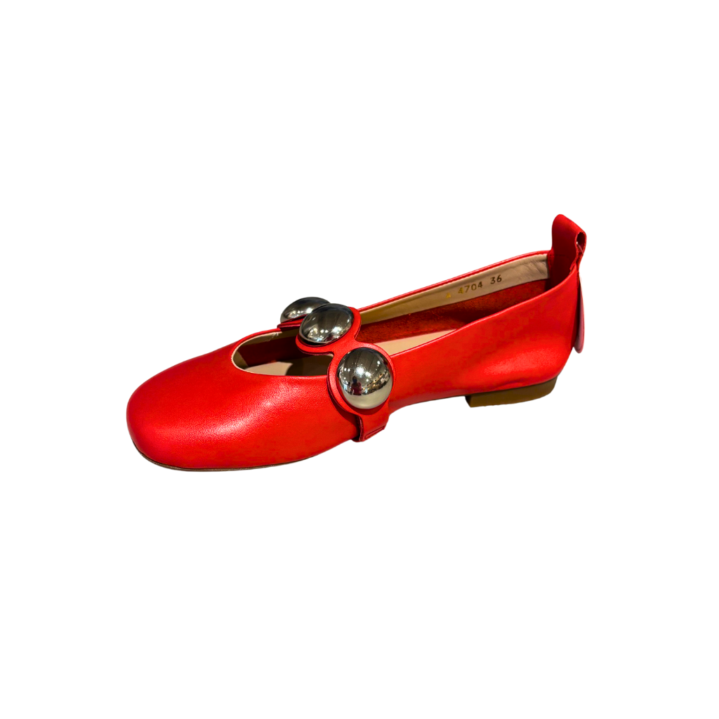 Red flat shoe with silver embellishments on a white background