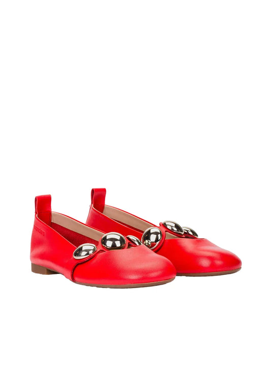 Pair of red shoes with decorative elements on a white background