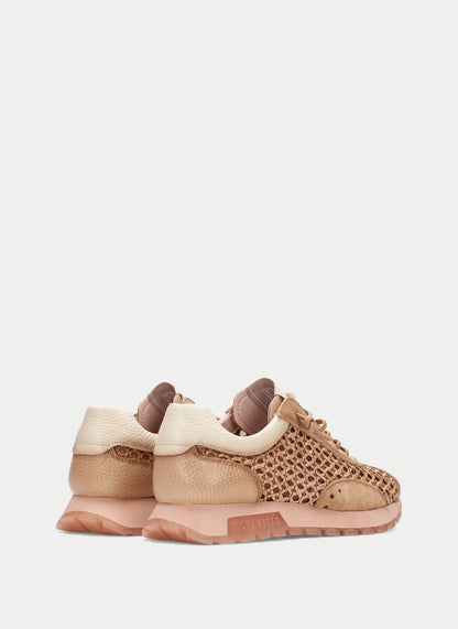Pair of beige and brown sneakers on a light gray background