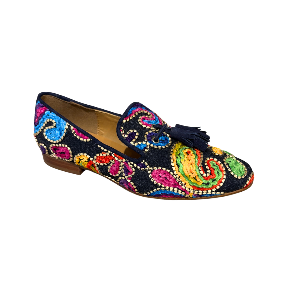 Colorful embroidered shoe with tassels on a white background