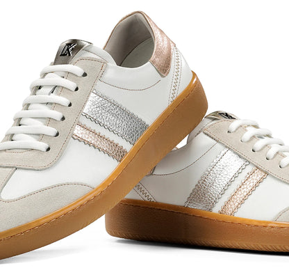 Pair of white sneakers with gum soles on a white background