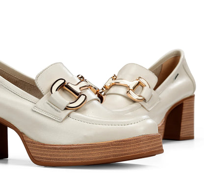 White shoes with gold buckles on a white background