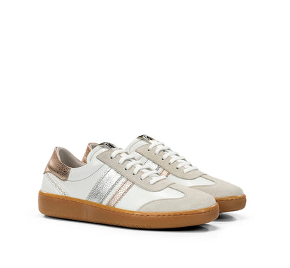 Pair of white sneakers with gum soles on a white background