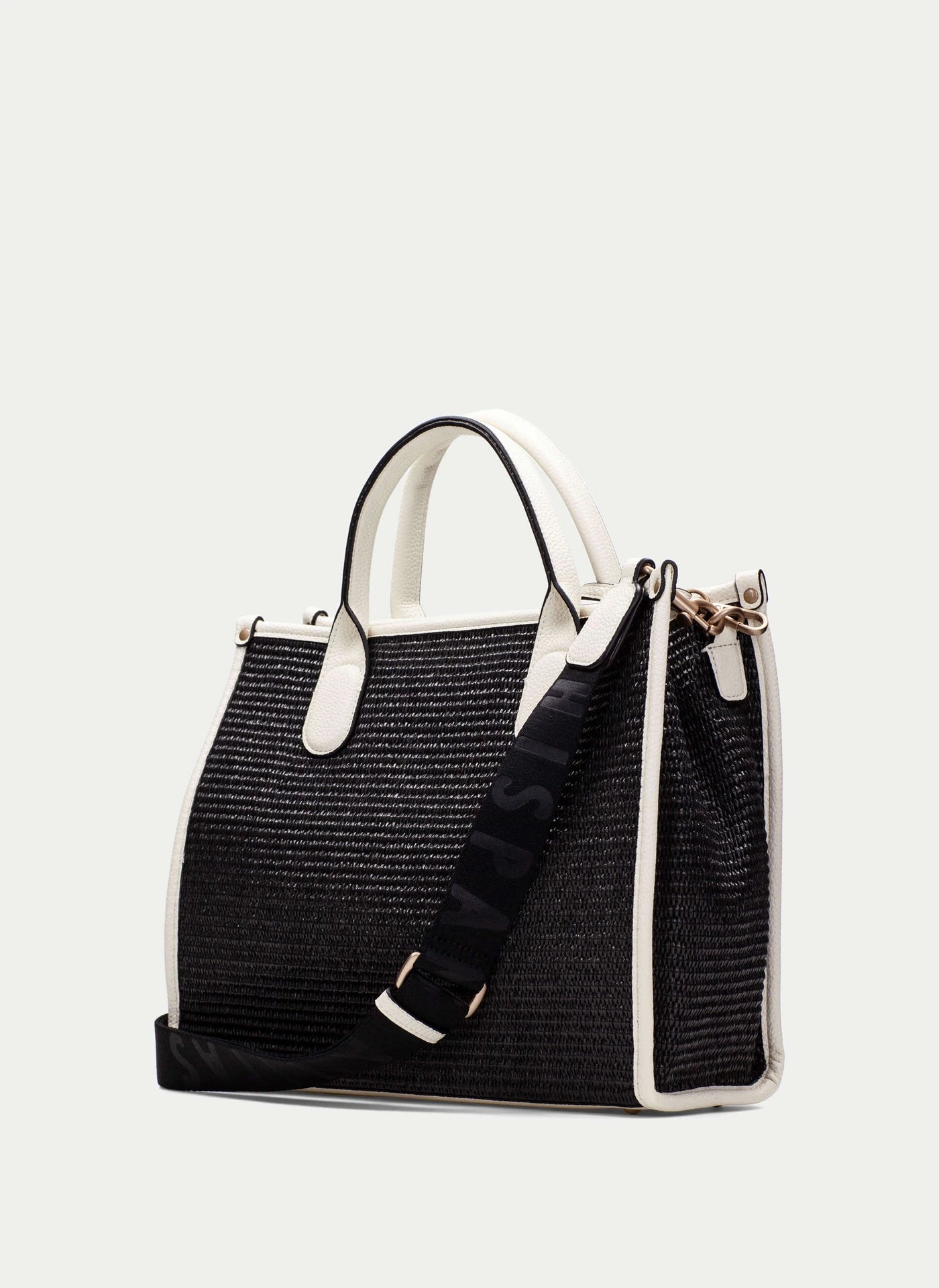Black straw handbag with white accents on a light gray background