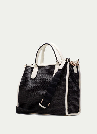 Black straw handbag with white accents on a light gray background
