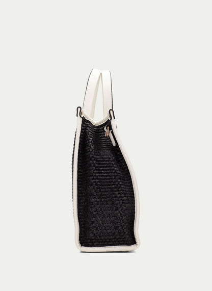 Black textured bag with white trim on a light gray background