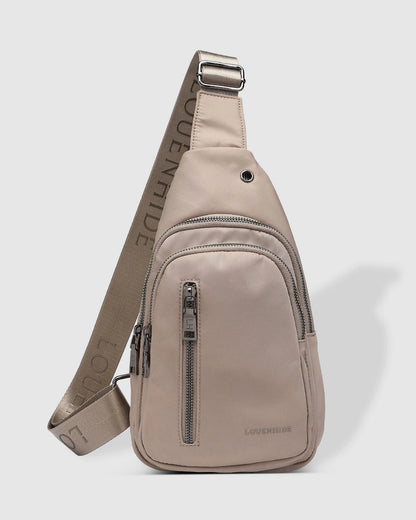 Beige sling bag with visible brand name on a light gray background