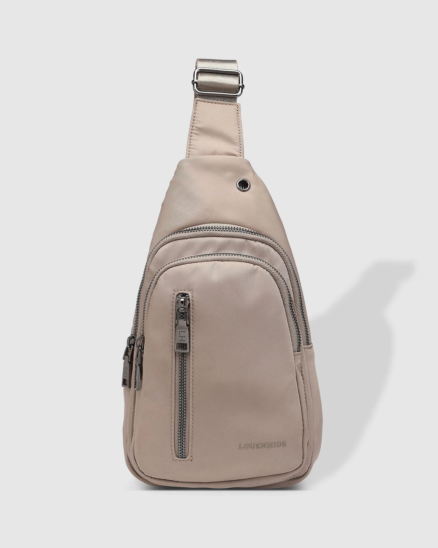 Beige sling bag with zippers on a white background