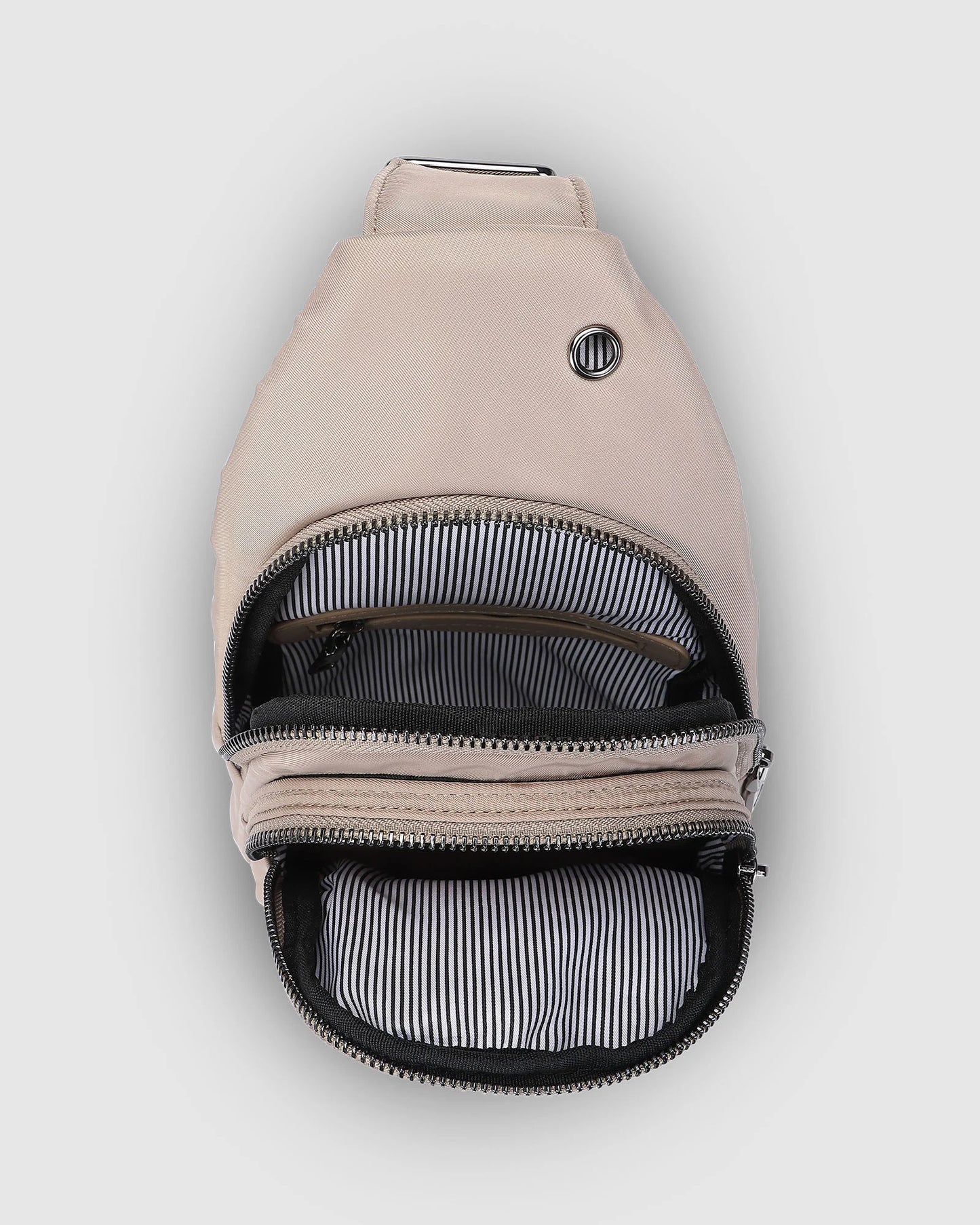 Inside of beige sling back showing 2 zipper pockets.