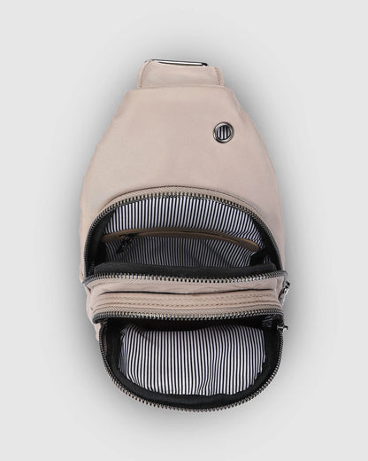 Inside of beige sling back showing 2 zipper pockets.