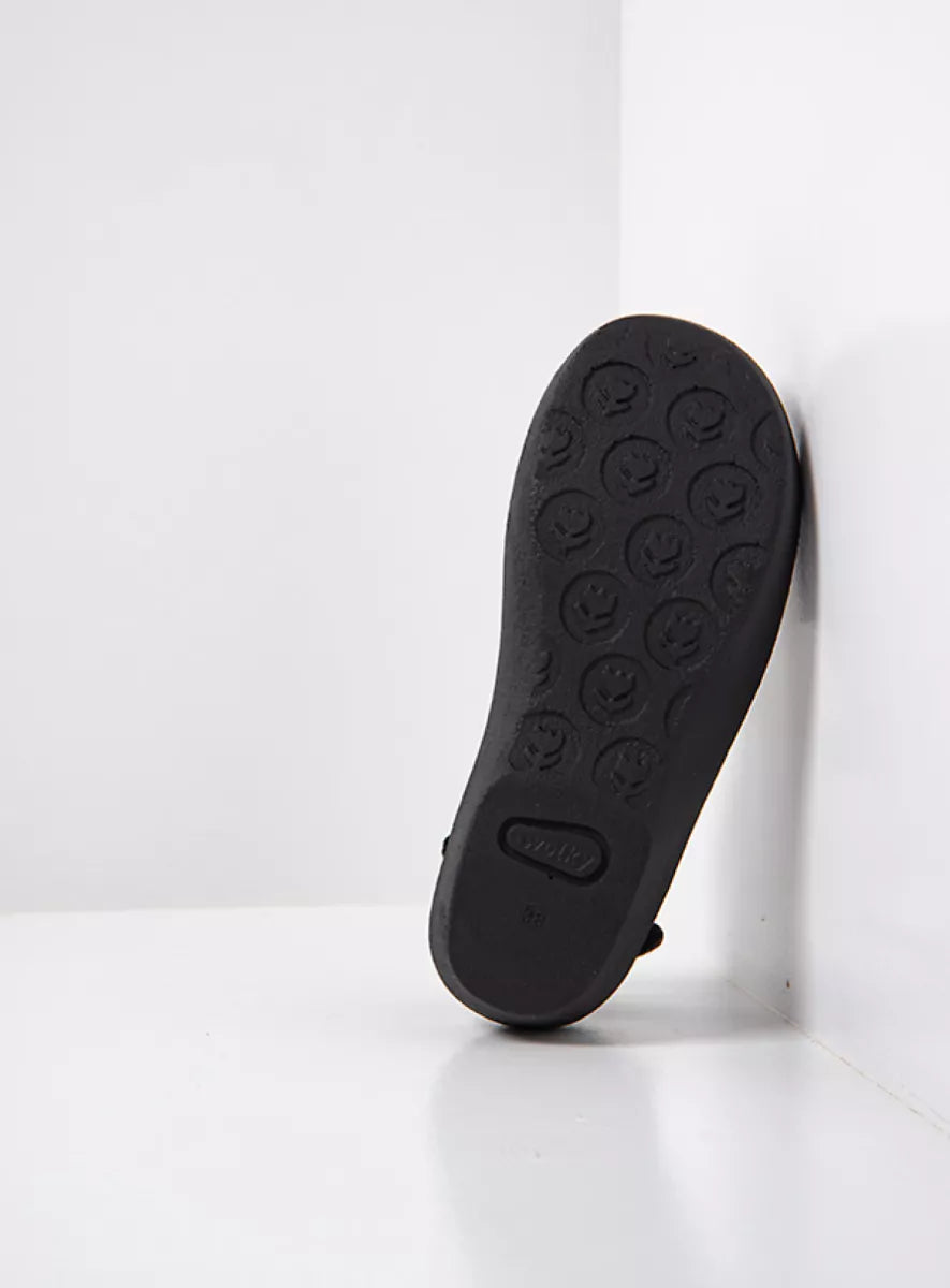 Black shoe sole with a textured pattern on a white background