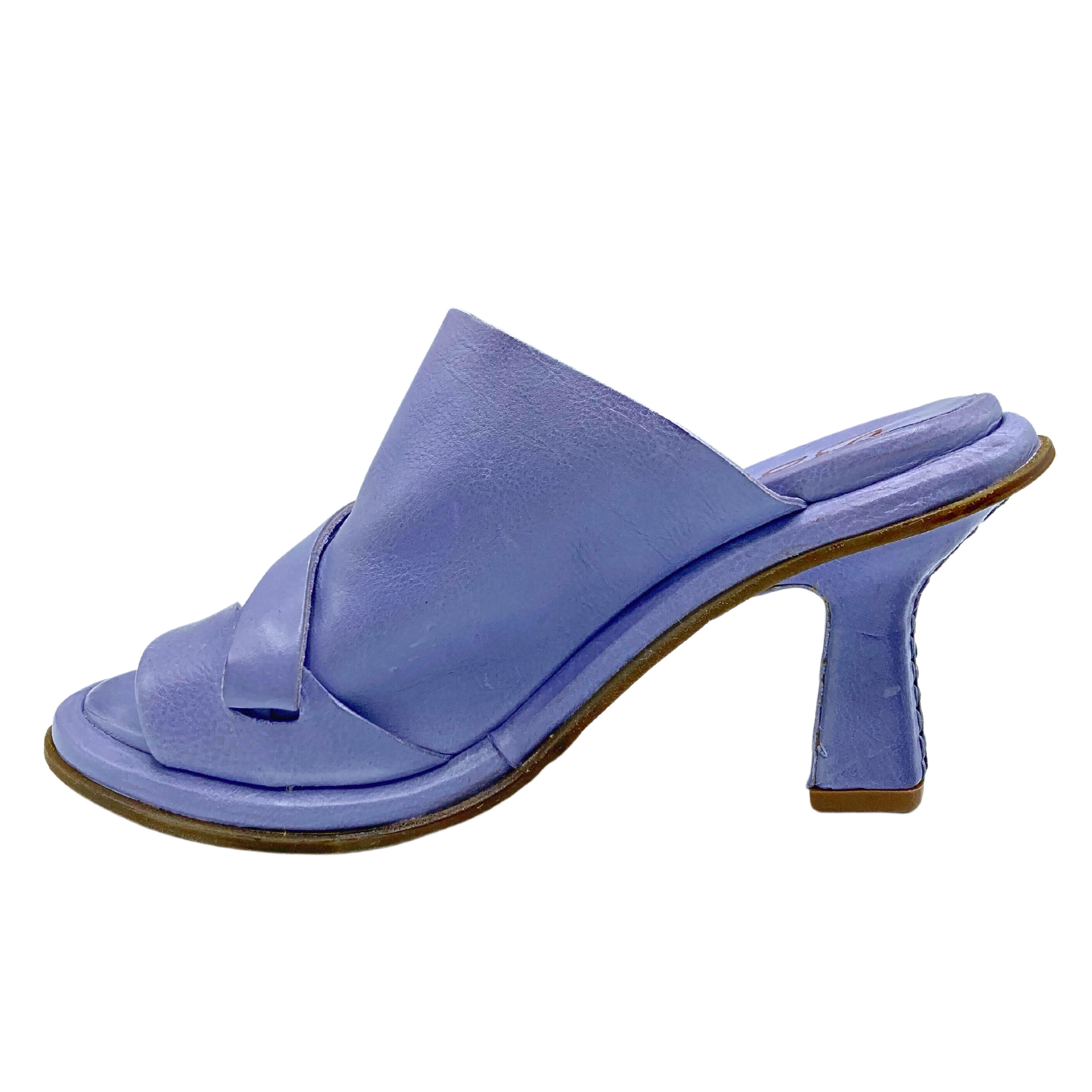 Inside view of right mule sandal. Tulip shaped heel.  Contrasting natural tone sole