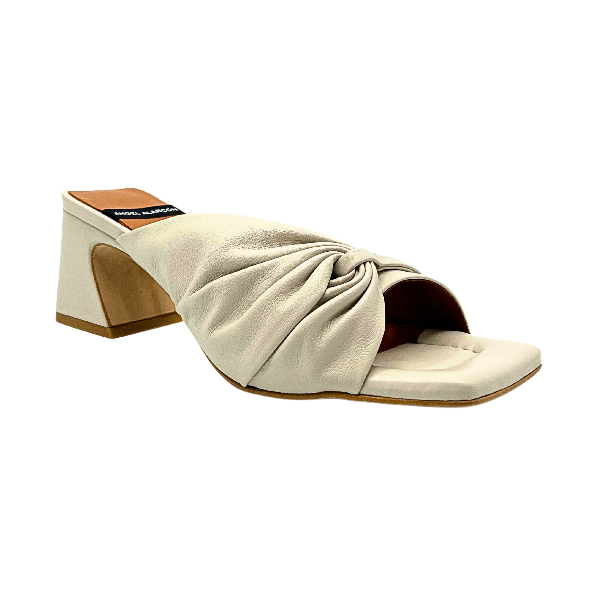 Angel Alarcon Gala mule pictured from outside angle of right shoe.  Features puckered rosette detail across the top on outside