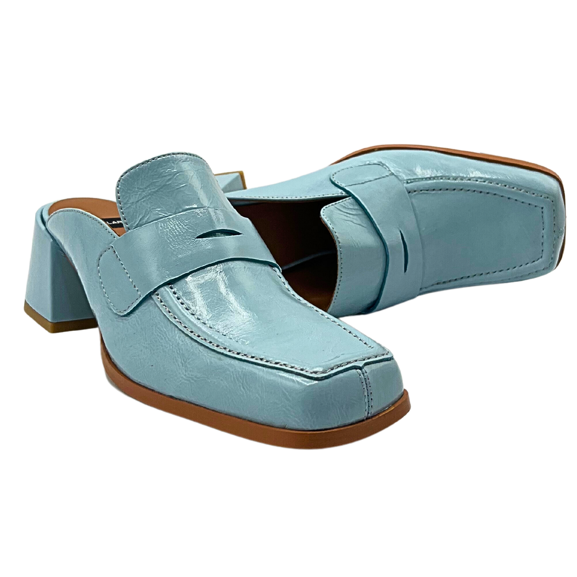 Picture of a pair of heeled loafers.  Slip on style with square toe in a baby blue