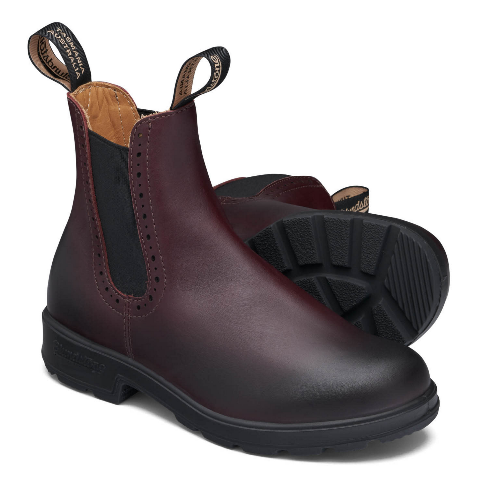 A pair of maroon coloured leather boots with brogue accent along the elastic sides.