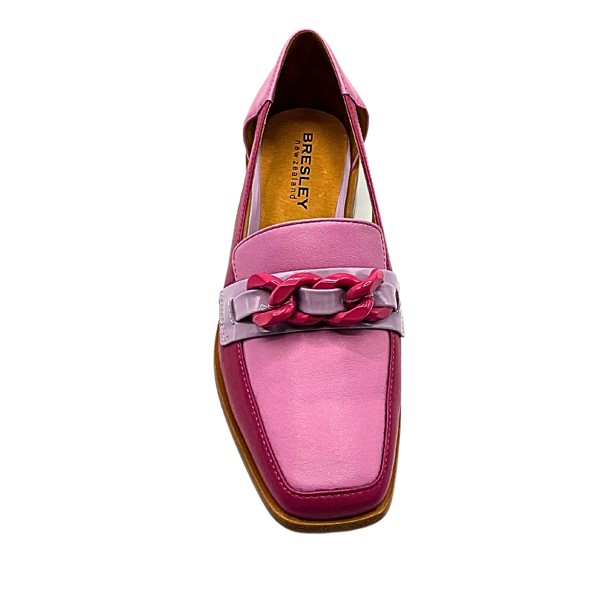 Top down view of loafer in a fuschia color body with pink top and silver band at forefoot.  Fuschia chain detail across silver band