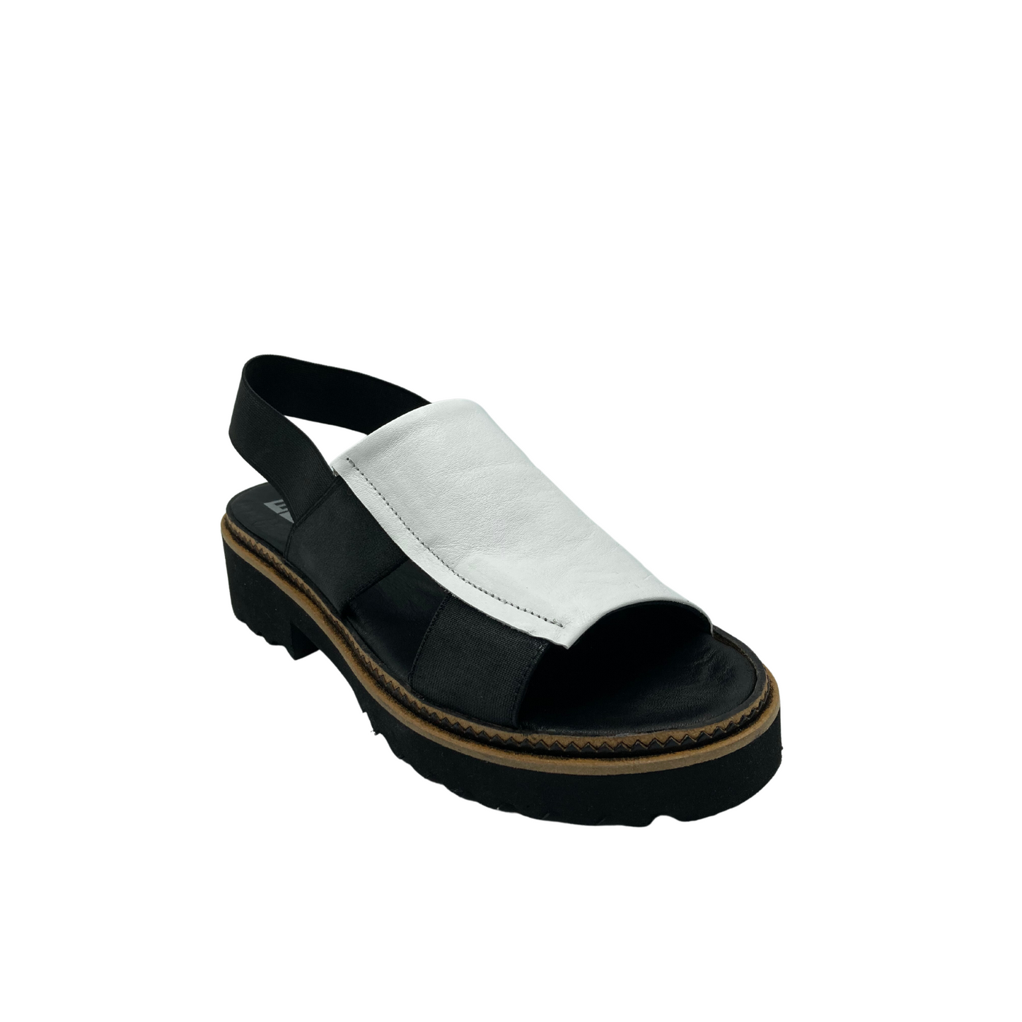 Angled front view of Bueno Amy in black/white combo.  Slip on style with elastic back strap.  White from inside to just past middle of top of foot.  Black down outside.  