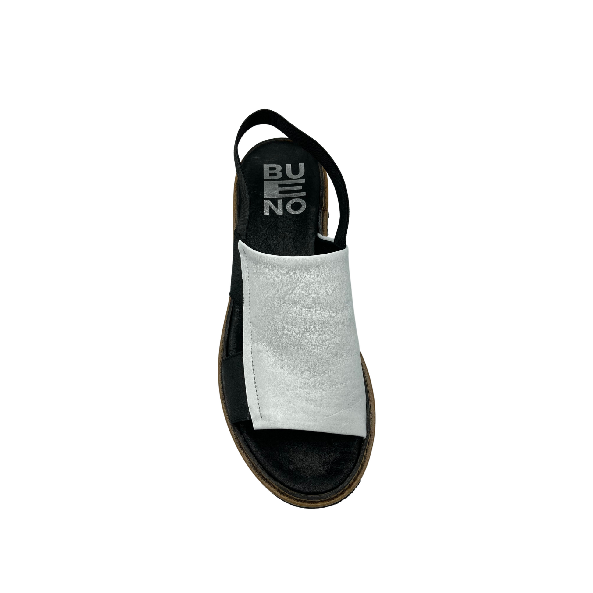 Top down view of Bueno Amy in the black/white combination.  Open toe slip on style with elastic back strap.  Wide leather band covers from toes to top of foot at ankle