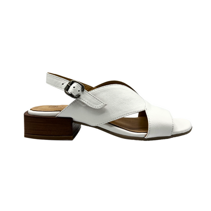 Outside view of low heel white sandal with side cut outs