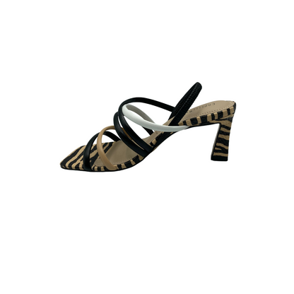 Inside view of strappy sandal.  Multiple straps across forefoot and up to top of foot.  Zebra stripes at toe box, heel and around sole.  All in neutral shade of taupe, black and white.