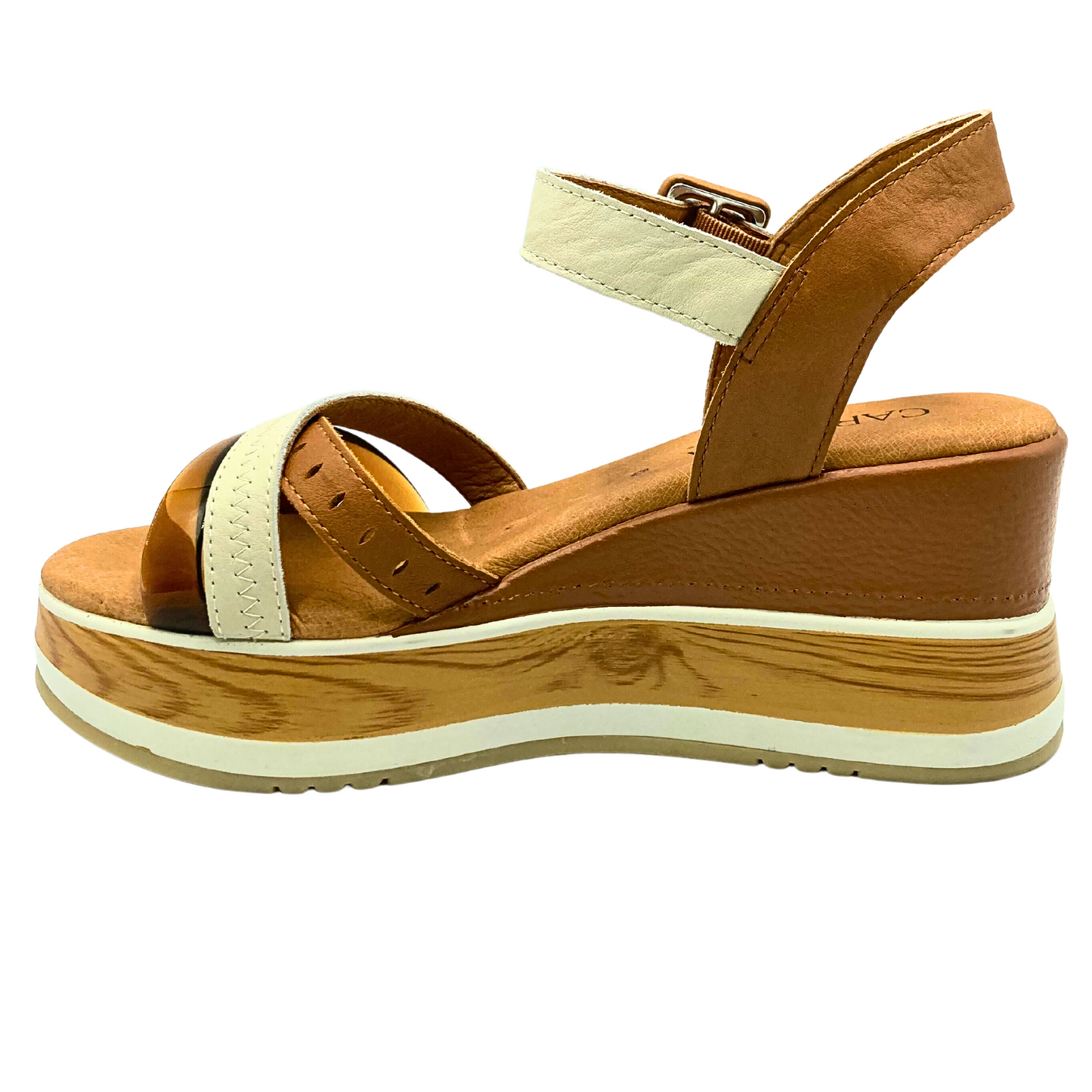 Inside view of wedge sandal with lots of variations in color and texture.  Open toe and heel but does have a back and ankle strap.  Three criss cross straps at the front and a faux wood panel in the platform wedge