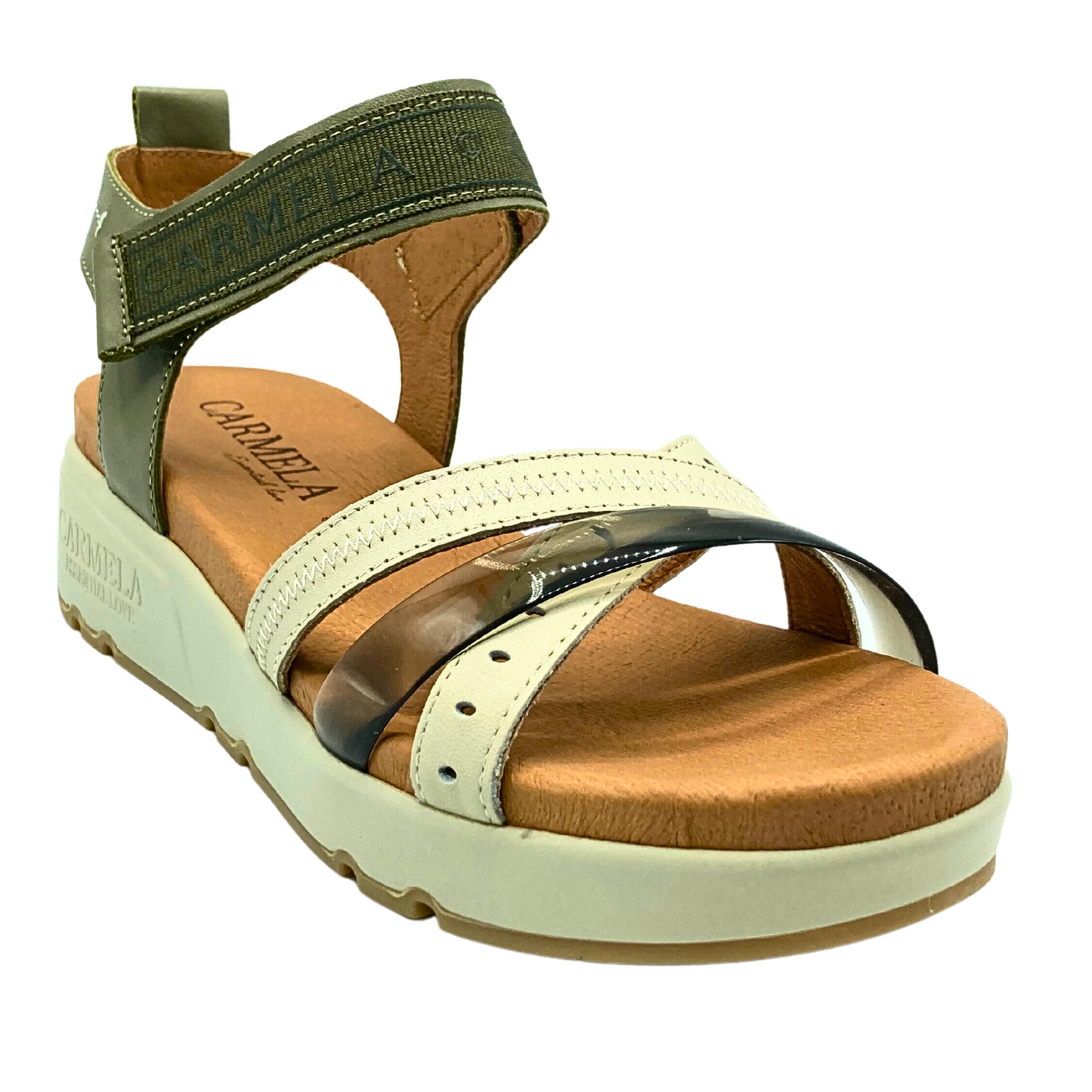 Angled front view of a low wedge sandal done in cream and khaki