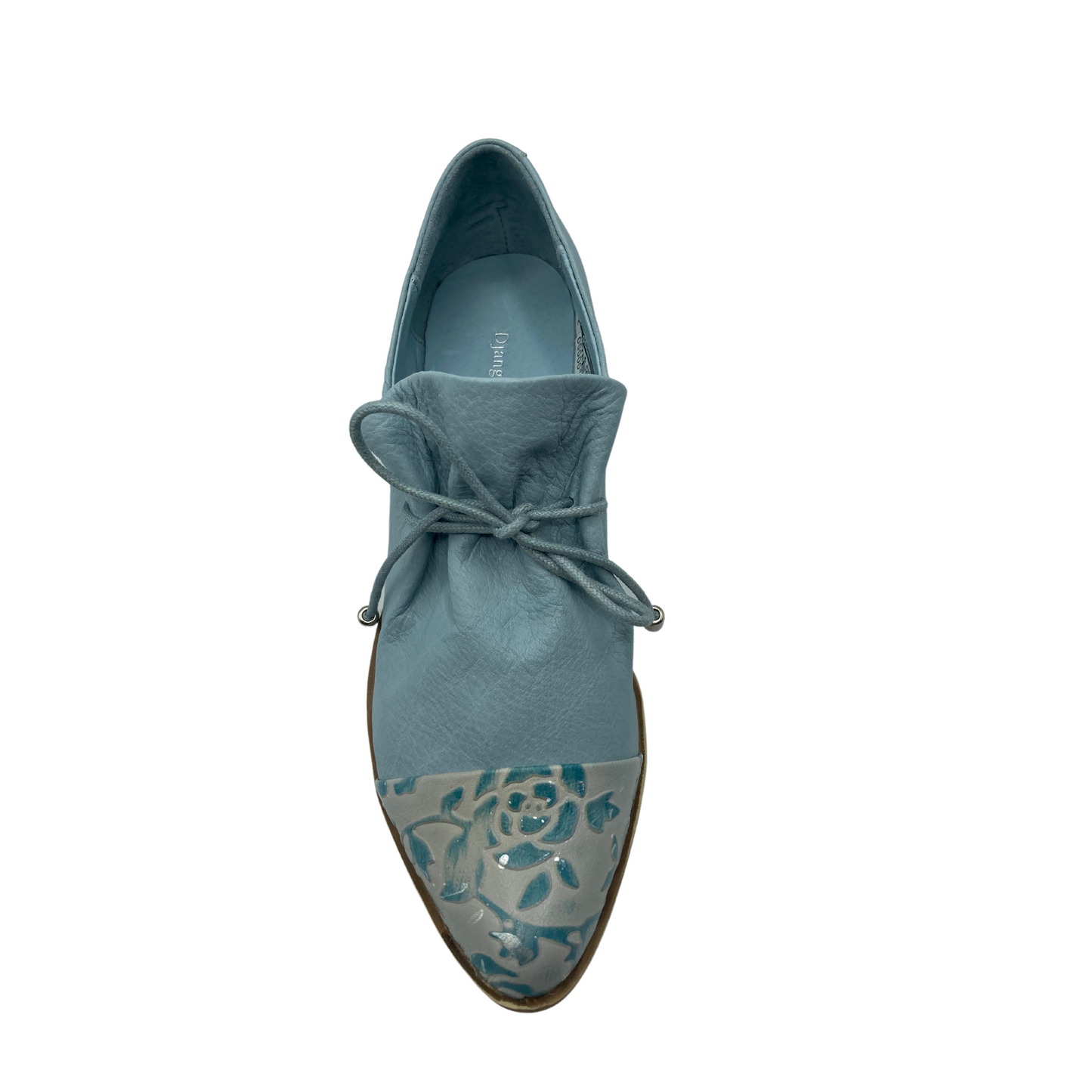 Cute little loafer in denim blue with a toe cap in an embossed floral blue/silver leather.  Shoe is all one piece with the tongue attached and ruched by the laces