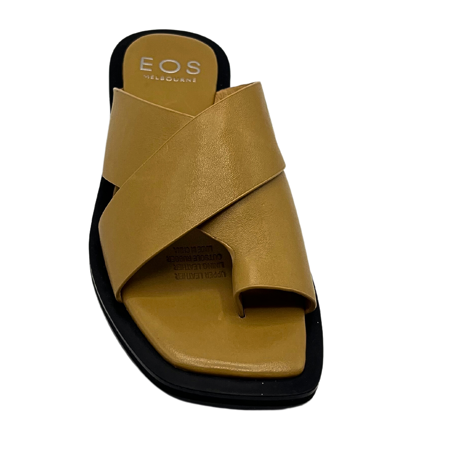 Tope down view of a leather slip on mule sandal.  Cross straps and toe sleeve keep it secure.  Shown in a  golden tan color