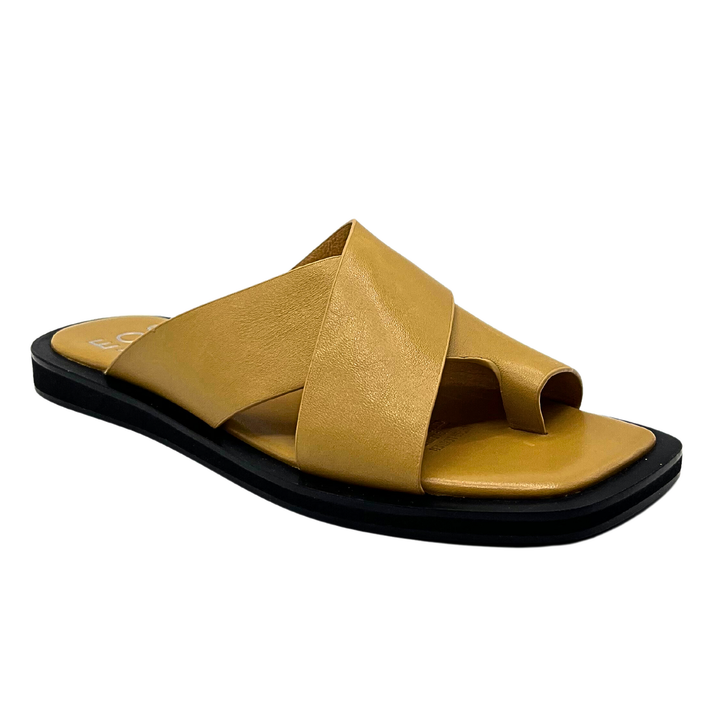 Angled side view of a flat mule sandal in a tan/gold color.  
