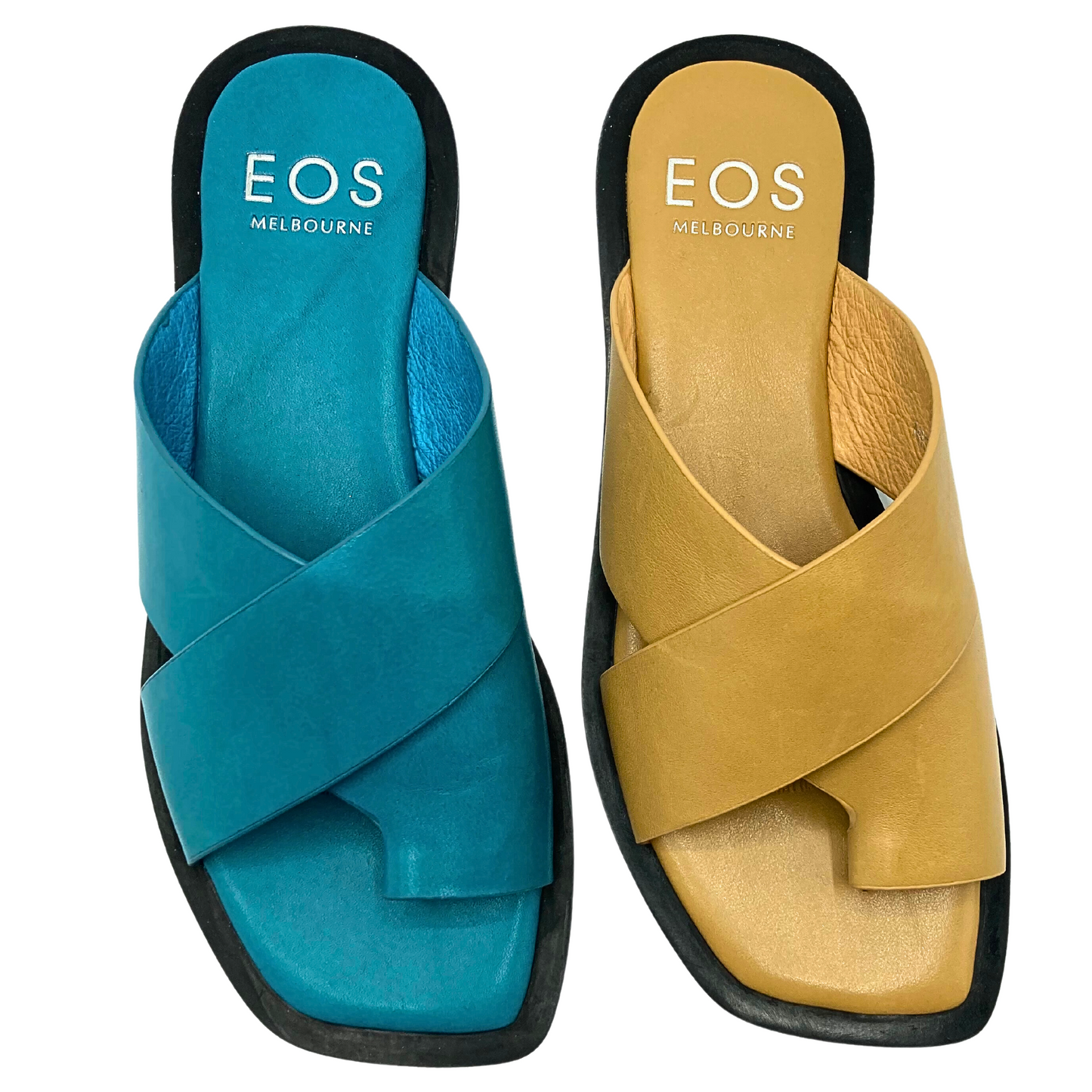 Top down view of slip on flat sandals in a blue and golden /tan