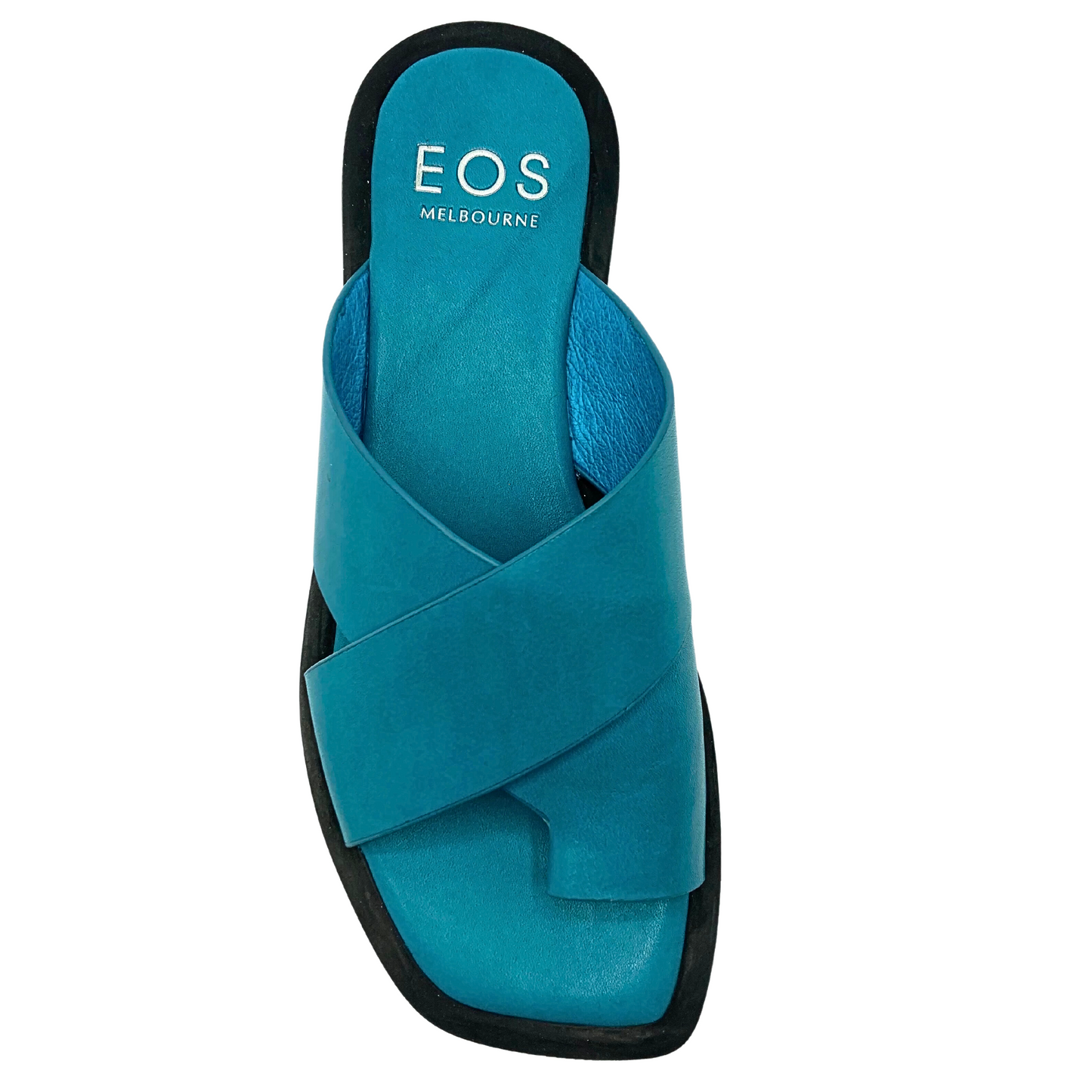 Top down view of a flat, blue leather sandal.  Black extended sole wraps up to provide a design element.  Cross straps and toe sleeve