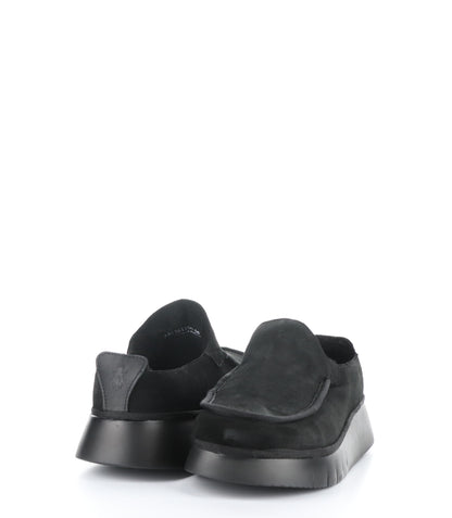 A pair of black, suede slip on shoes are pictured. One shoe is faces to the front, the other shoe is pictured from behind.
