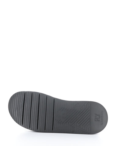 The rubber sole of a shoe is pictured with normal tread.