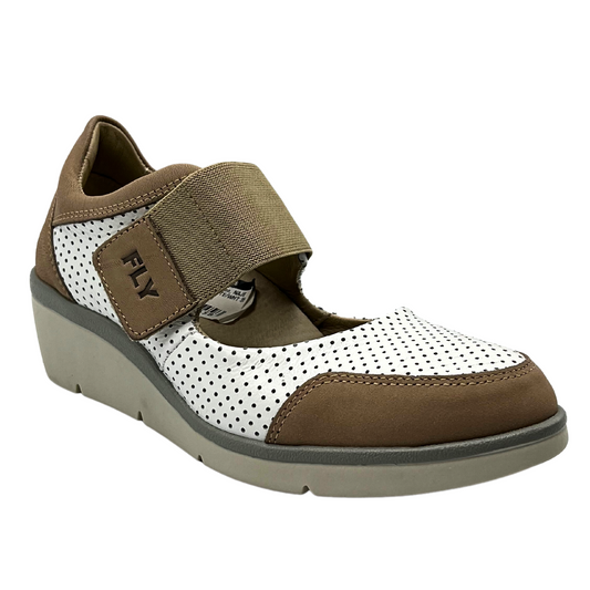 Angled front view of Mary Jane style shoe.  Two-tone with white perforated leather and tan smooth