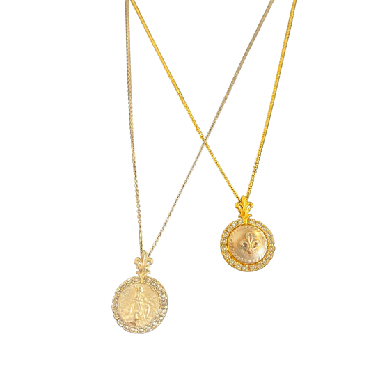 Two gold necklaces with engraved medallions.